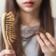 Close-up,Young,Woman,Brushing,Her,Hair,And,Have,Many,Hair